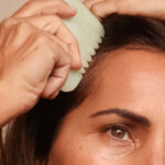 Model doing the Gua Sha Comb Massage