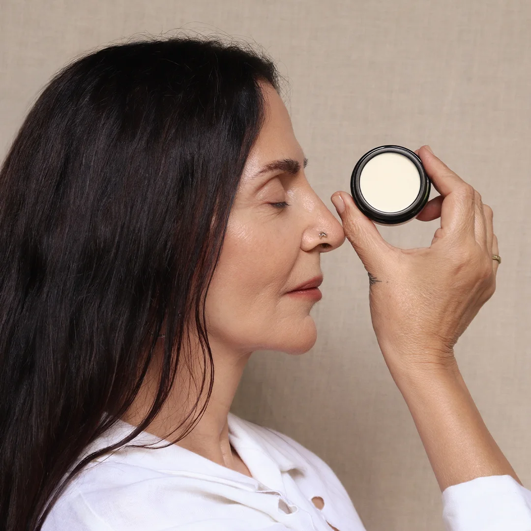 Woman holding a small jar of Zen Solaire — LE PURE's certified organic biological sunscreen balm SPF 20