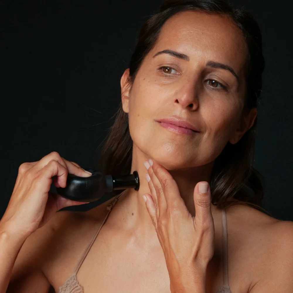 LE PURE Face Cupping Ritual Woman applying face cupping with black cups